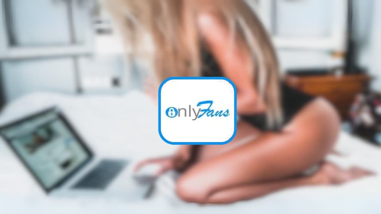A blurred image of a woman in a black outfit sitting on a bed, using a laptop with the what is OnlyFans logo superimposed in the foreground.